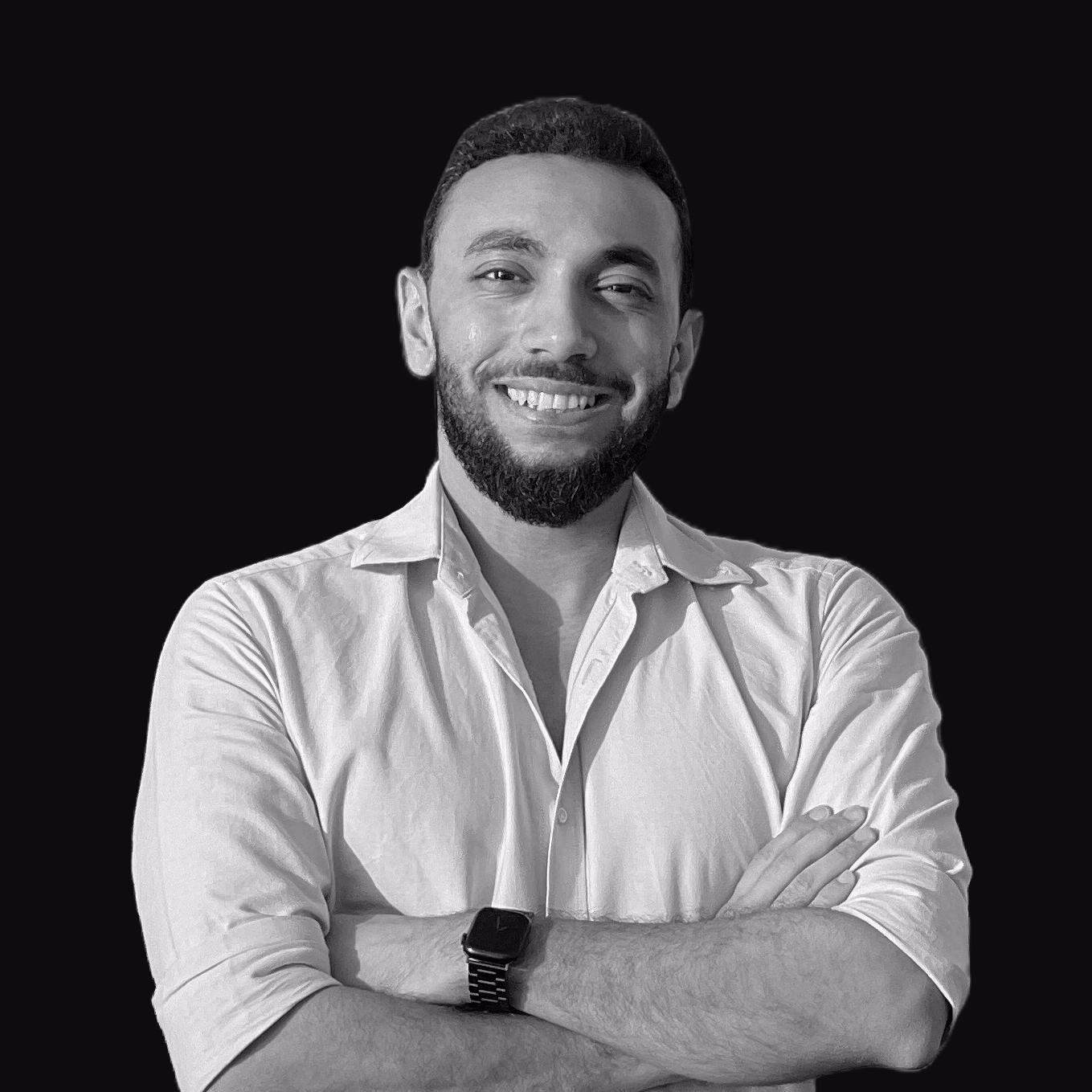 Kirlos Yousef smiling with his arms folded